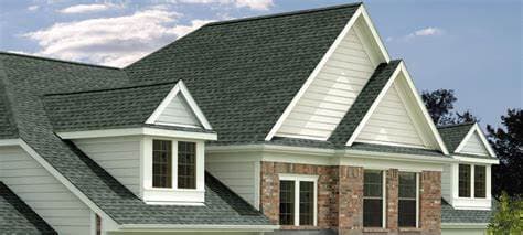 Home with a green architectural asphalt shingle roof and white gables